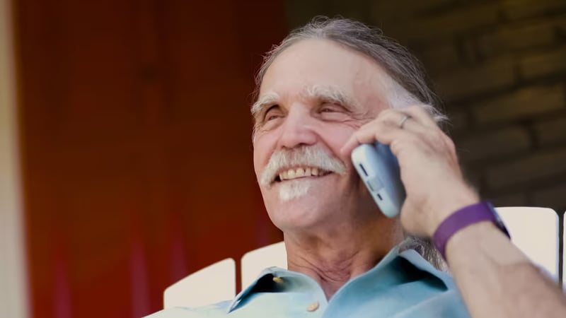 Smiling older man talking on a mobile phone